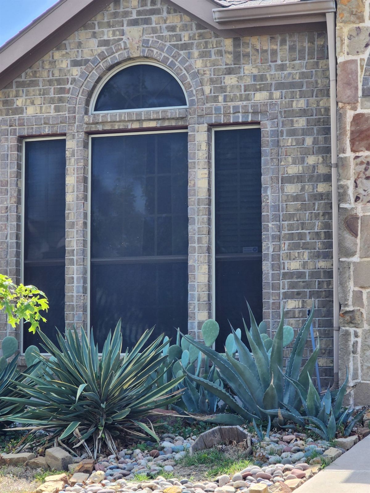 Window solar screens installed on stone home in Weatherford TX